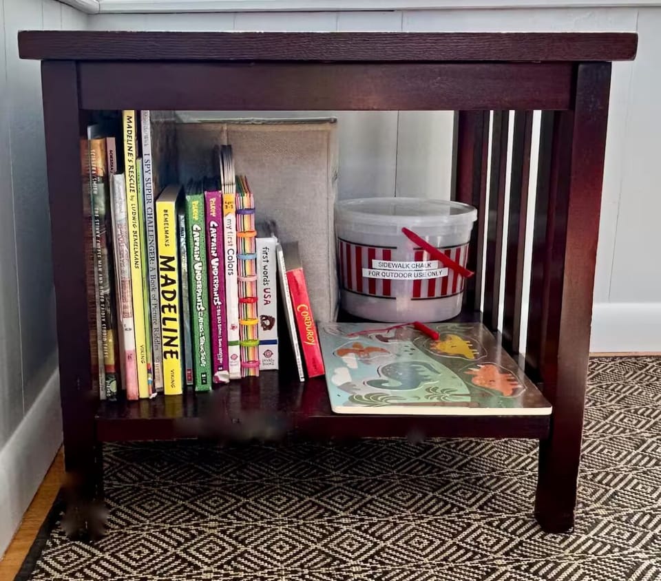 Kids’ books and sidewalk chalk on enclosed front porch