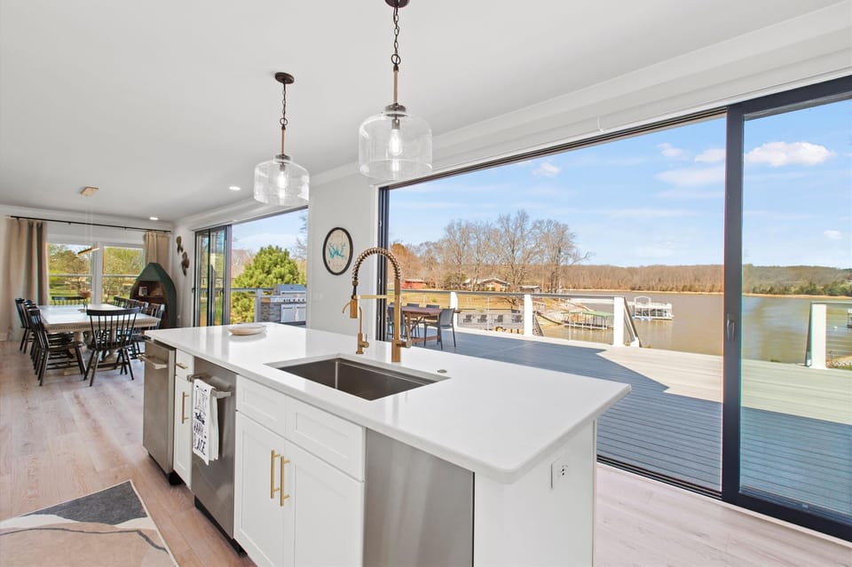 Effortlessly host gatherings with our functional and beautiful kitchen island bar, complete with two dishwashers and scenic lake views.