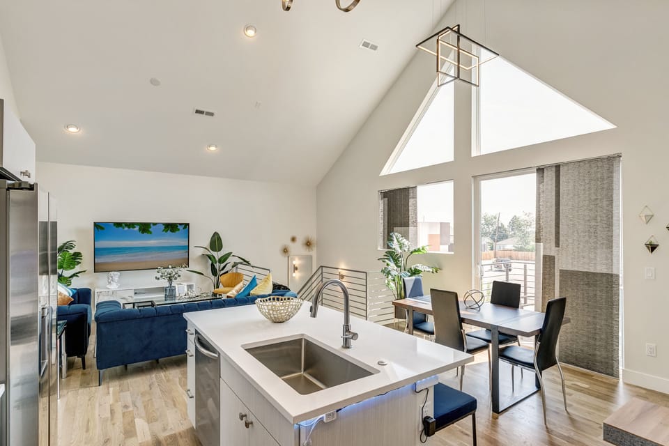 Large kitchen island with farmhouse sink and dishwasher