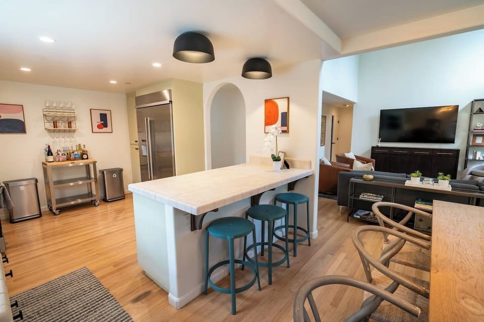 Full stocked kitchen with island seating for three