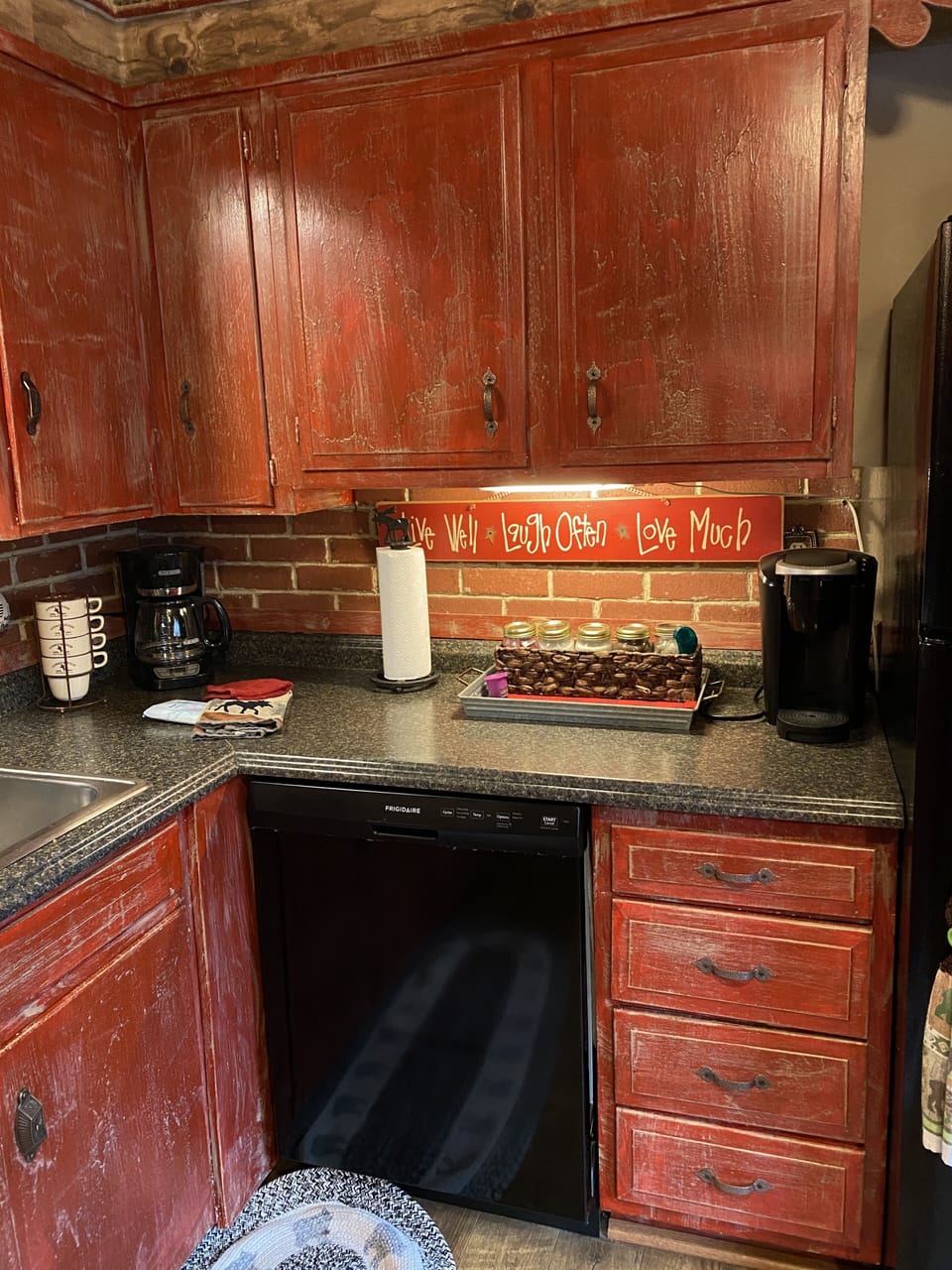 Kitchen with dishwasher, coffee maker and a Keurig. 