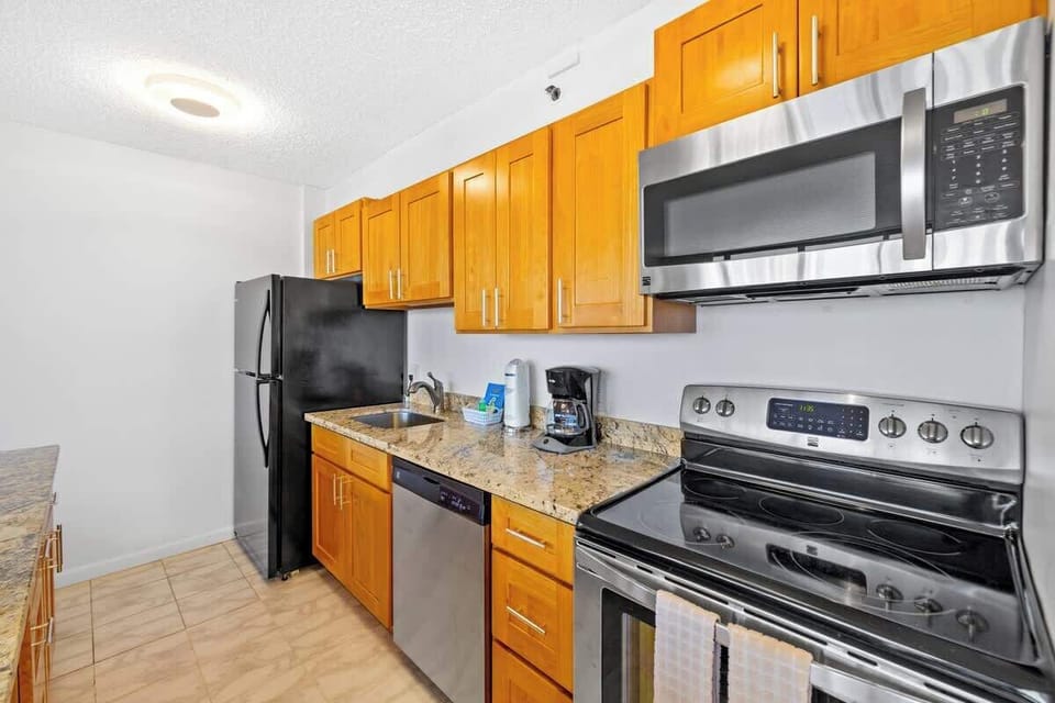 Fully equipped kitchen includes refrigerator, dish washer, stove, oven, and microwave