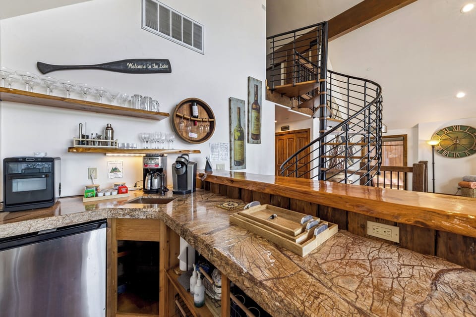 Wet bar and coffee station with live-edge wood details, beverage fridge, and plenty of space for gathering