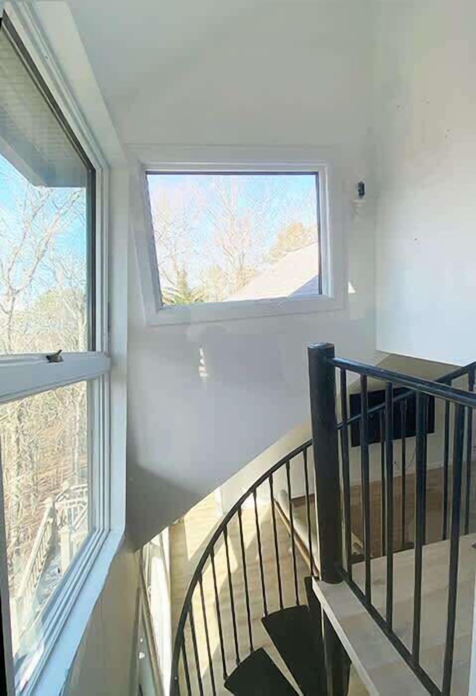 Spiral stair connecting Living Room to Family Room