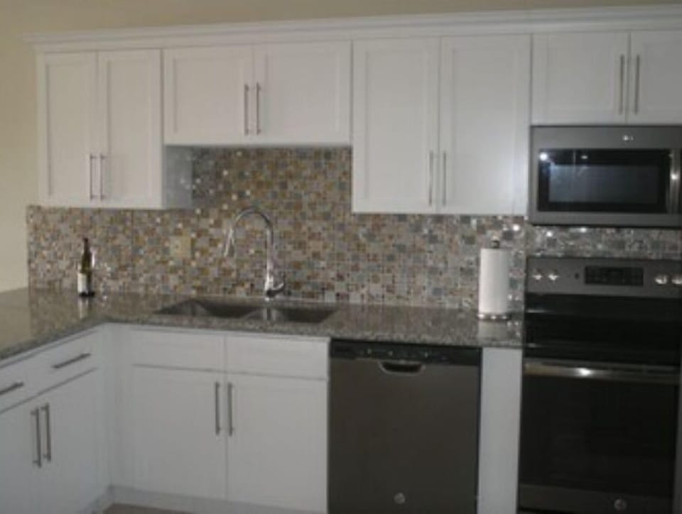 Open concept kitchen with dishwasher, microwave, GE stove and GE refrigerator