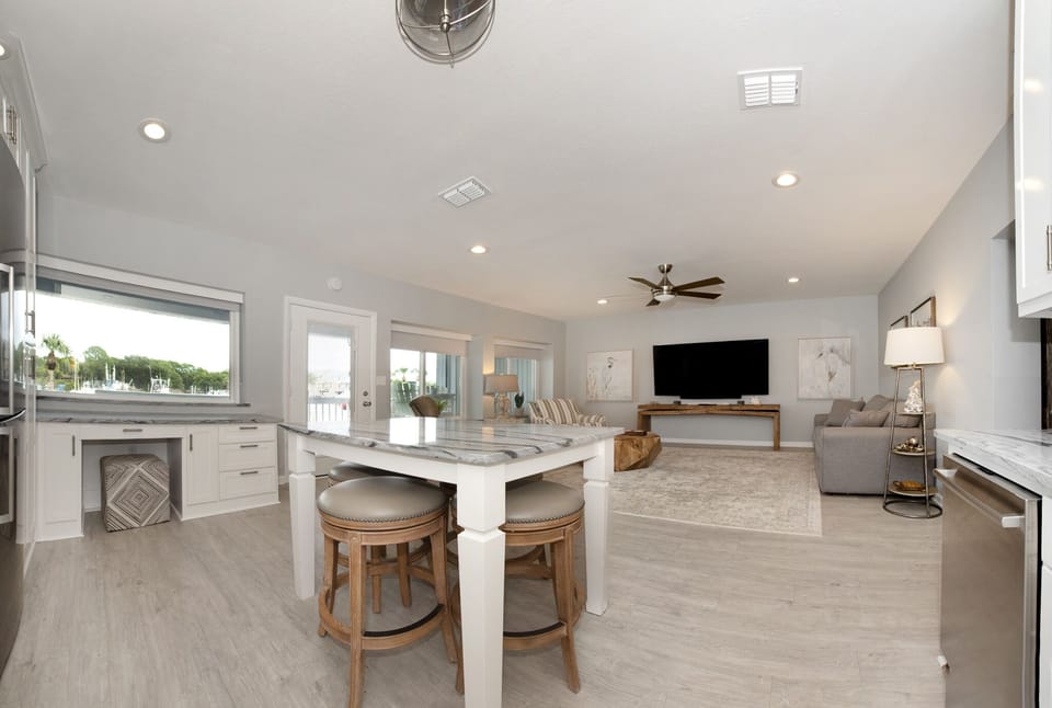 Living area, open to kitchen, marina view, 85-inch smart TV, double sleeper sofa