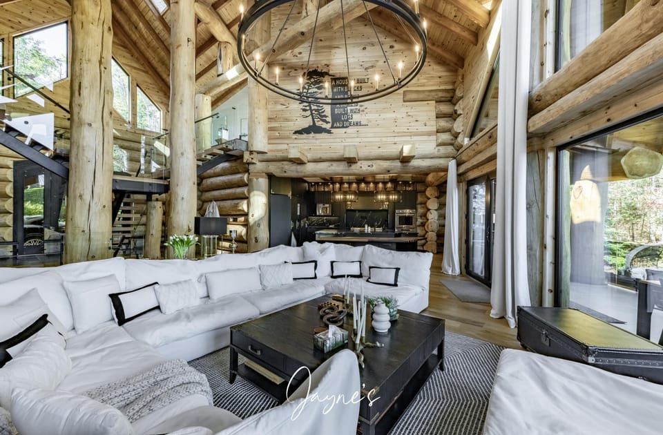 Spacious living room with soaring ceilings and cozy fireplace