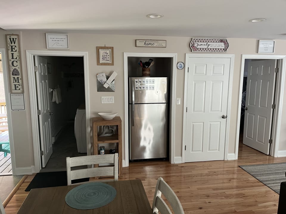entrance to bathroom, closet and full refrigerator.