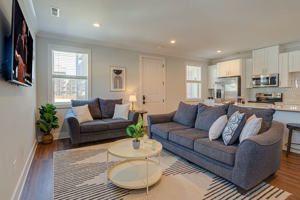 Bright and open living space with smart TV. -Unit 1-