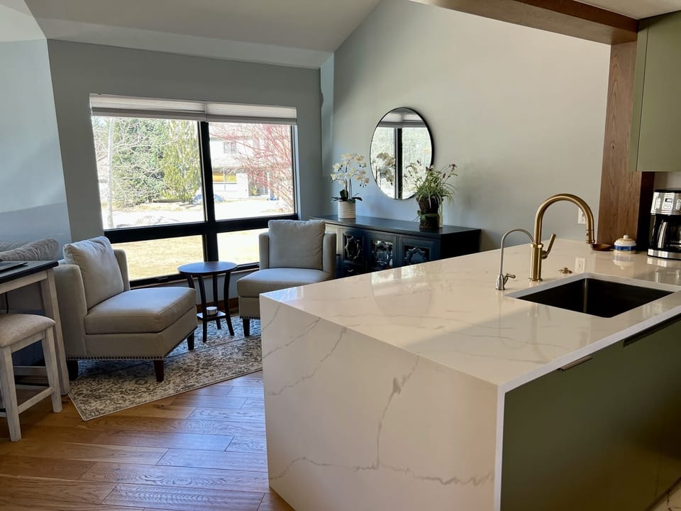 The quartz countertop overlooks the reading nook at the front of the house.