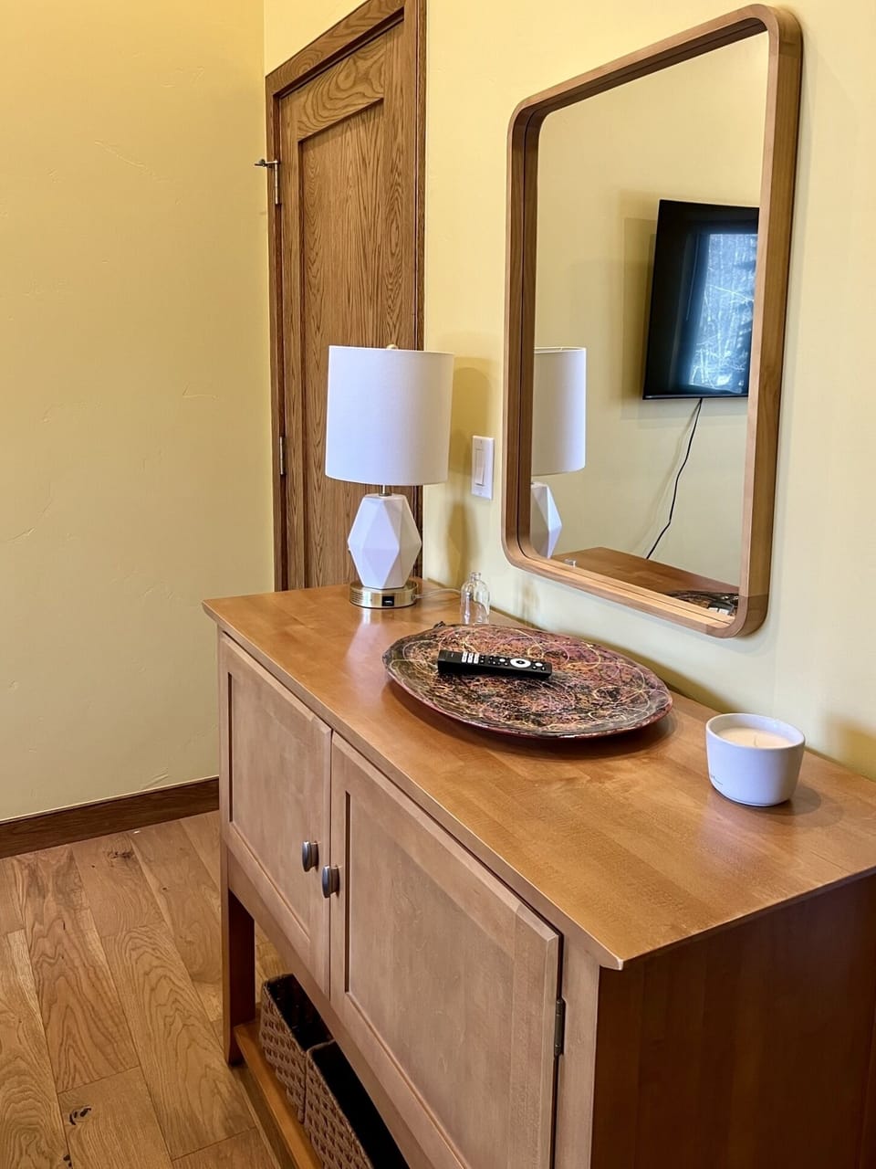 The guest bedroom has a nice cabinet for storing your clothes.