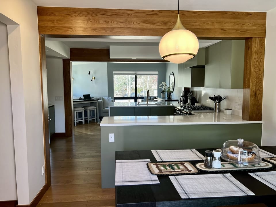This view is from the back deck showing the dining room, kitchen, and nook.