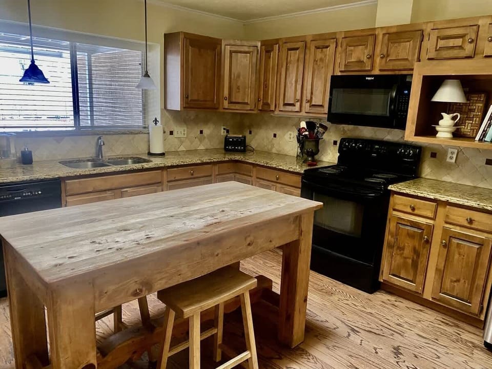 Rustic kitchen and dining area with wooden cabinets and seating for the whole group