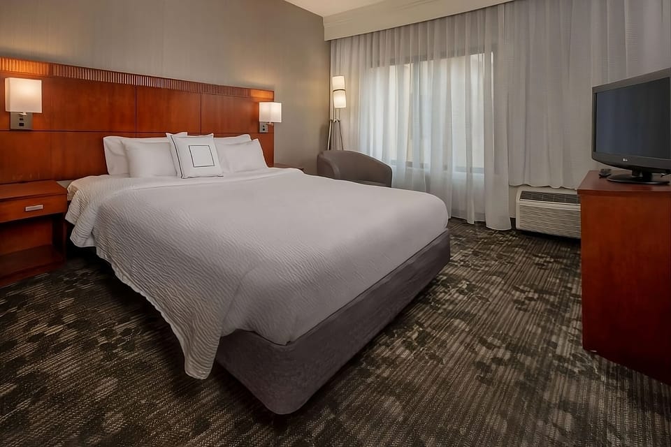 Unwind in a bright king room with crisp linens.
