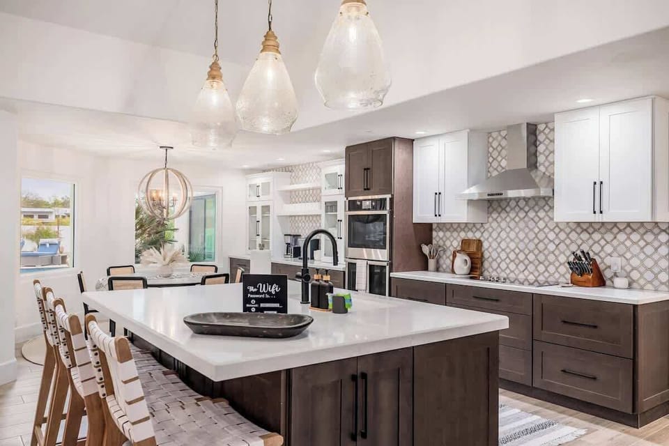 Step into your dream kitchen with gleaming white countertops, stunning pendant lighting, and custom two-tone cabinetry. With modern appliances and an open layout flowing to the dining space, you'll love every moment spent here.