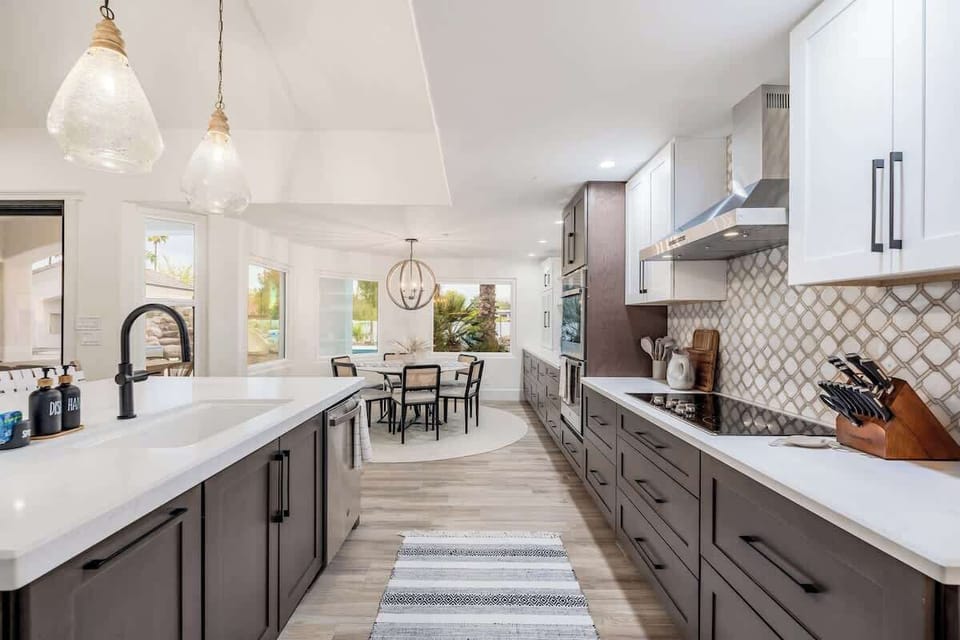 Your gourmet kitchen awaits with sleek countertops, modern appliances, and elegant tilework—perfect for cooking up vacation memories in this bright, stylish space.