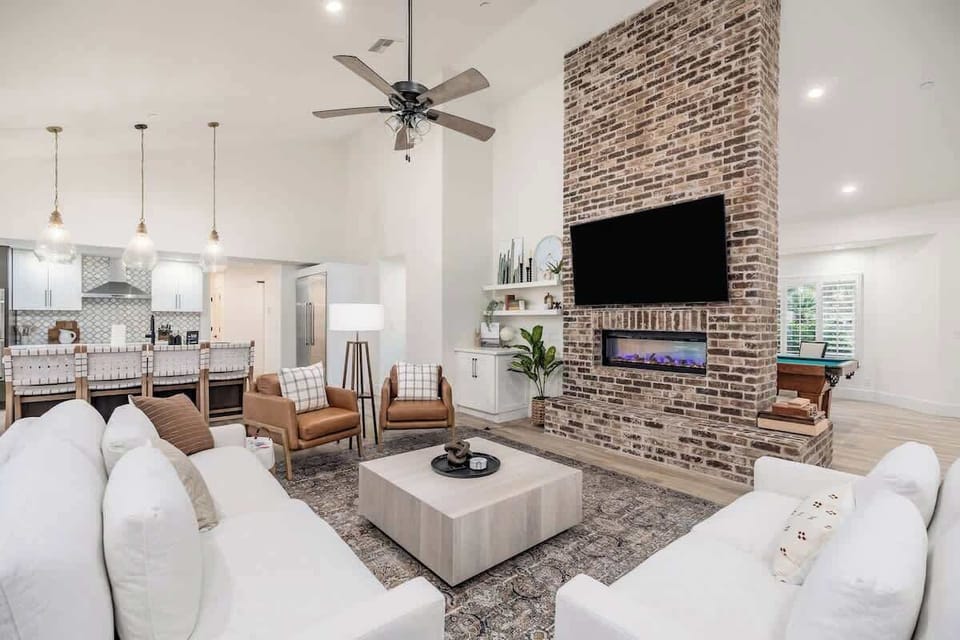 Unwind in your spacious living area, where plush seating and a cozy brick fireplace create the perfect spot to relax after a day of adventure.