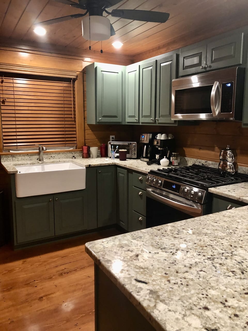 Open kitchen with high-end appliances and granite countertops throughout 