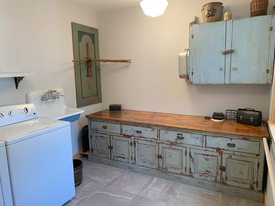 Large laundry room with washer and dryer and antique counter for folding clothes