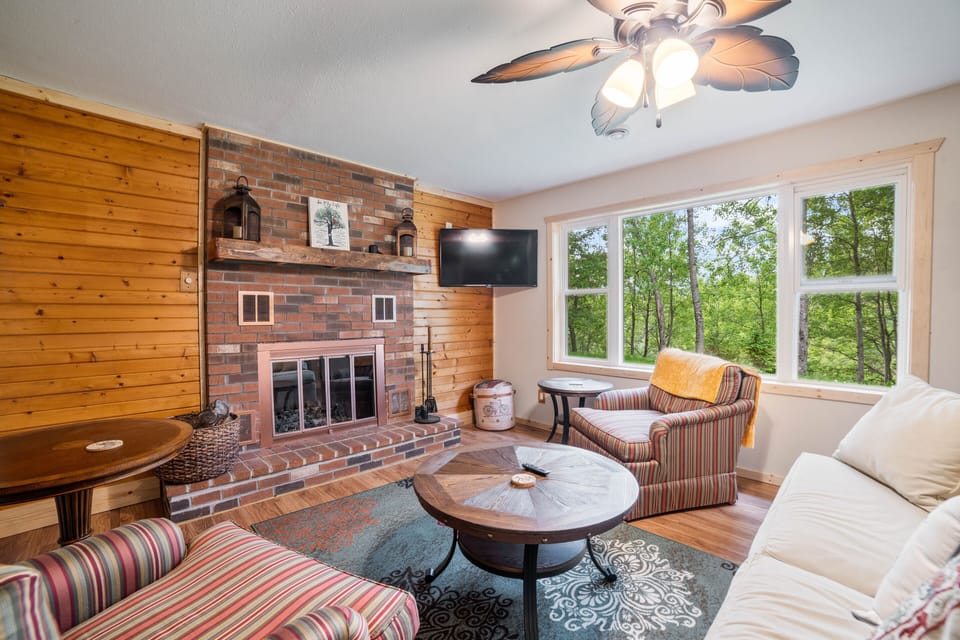 Living Room w/ fireplace, smart TV, wooded views out the enormous windows!