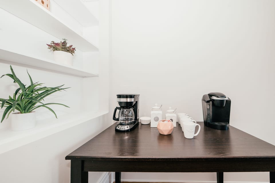 Drip coffee maker and Keurig available for guests with coffee, creamer and sugar