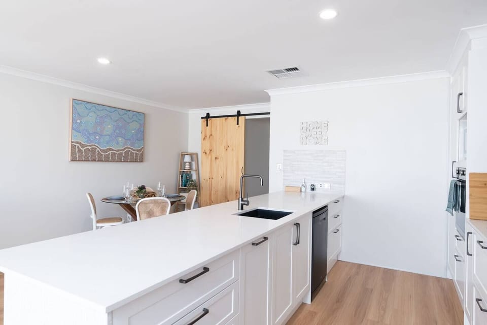 Modern kitchen with dining and modern appliances.