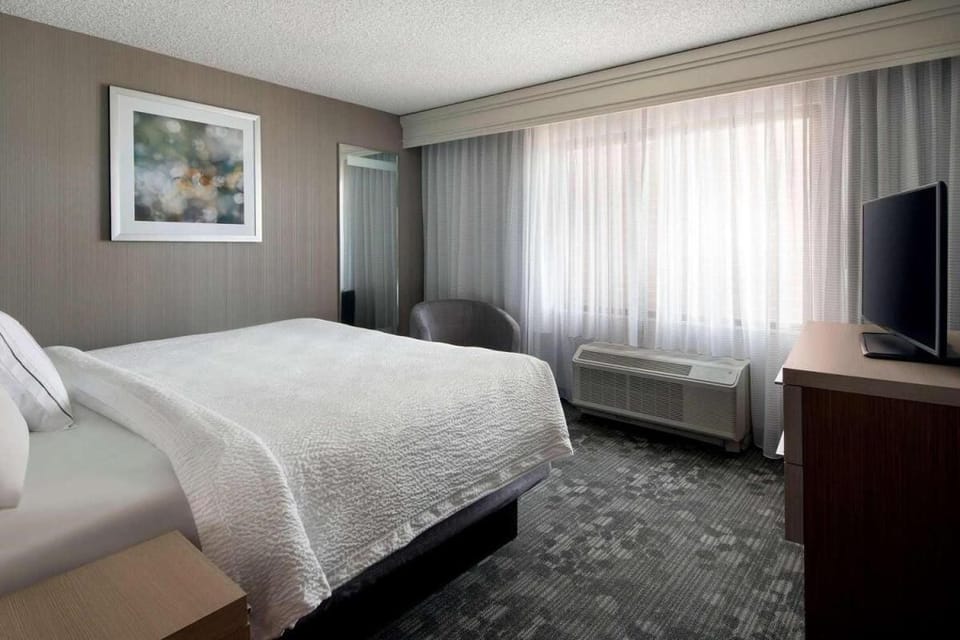 Settle into a calm bedroom with soft light and easy comfort.