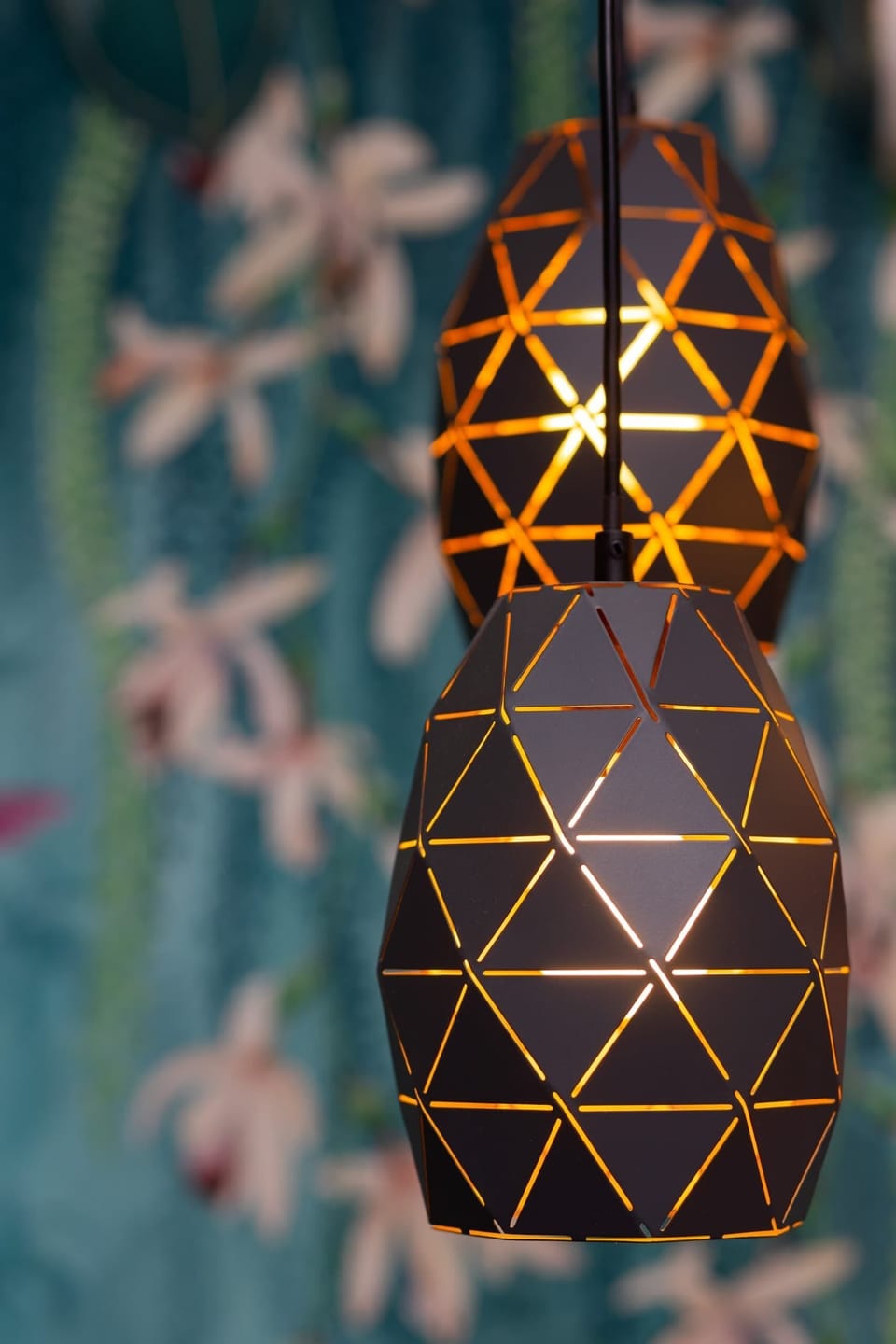 A close-up of a decorative pendant light with intricate design details.

