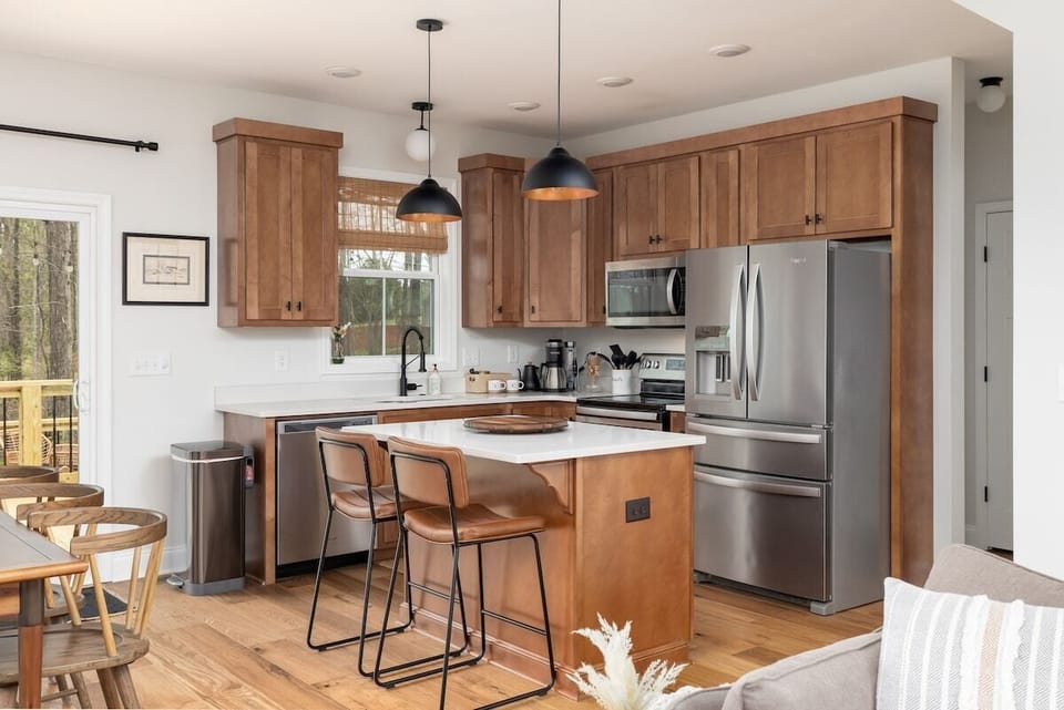 The kitchen is stocked with: Blender, Toaster, Plates, Bowls, Plastic cups, plates & bowls, Cookie Sheet, Pots, Pans, Tupperware, Coffee Cups, Drinkware, Silverware, Serving Tray, Wine Glasses, Mixing Bowls, Knife set, Cutting boards