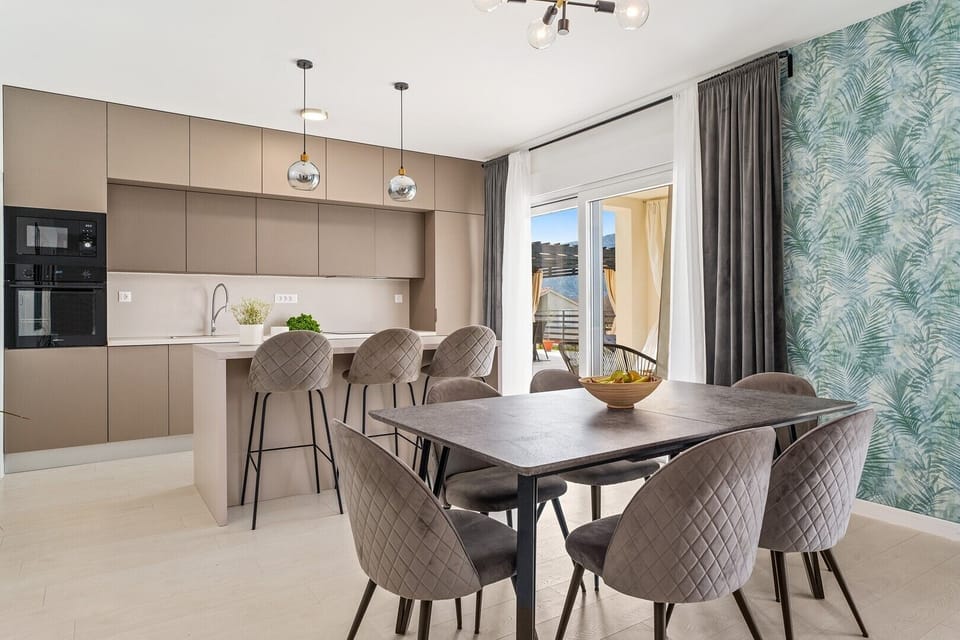 The dining area is on the ground floor with a table for 8 people.
