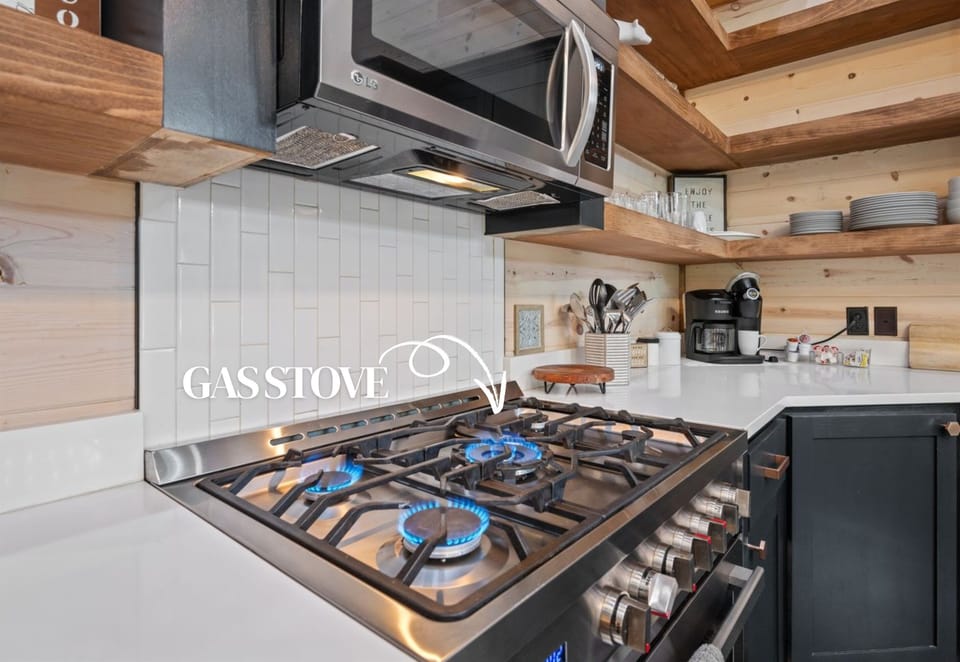 Fully equipped kitchen with modern appliances, open shelving, and plenty of prep space.
