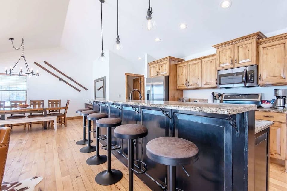 The large counter space and bar stools are great for meal prep and socializing.