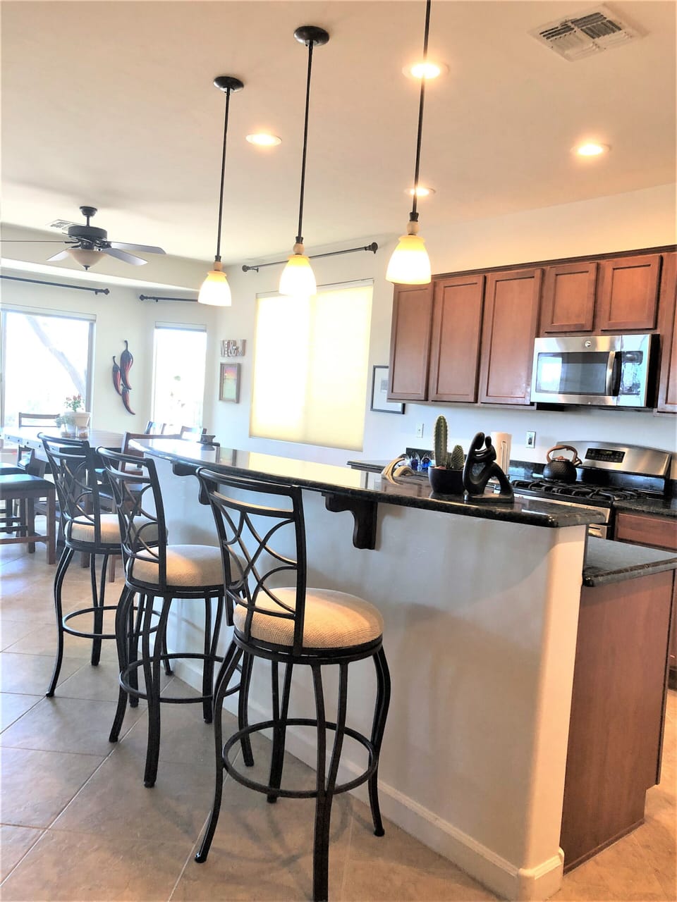 Kitchen Island with view of gas range and microwave in background