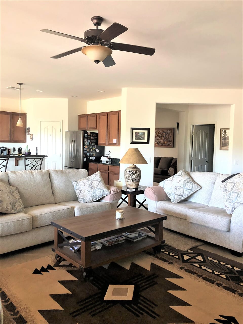 Living Room with view of entrance to den and utility room in the background