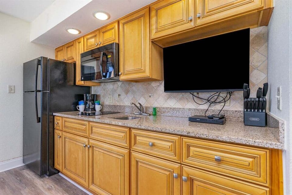 The well-equipped kitchenette features a microwave, mini-fridge, and coffee maker, making light meal prep a breeze.