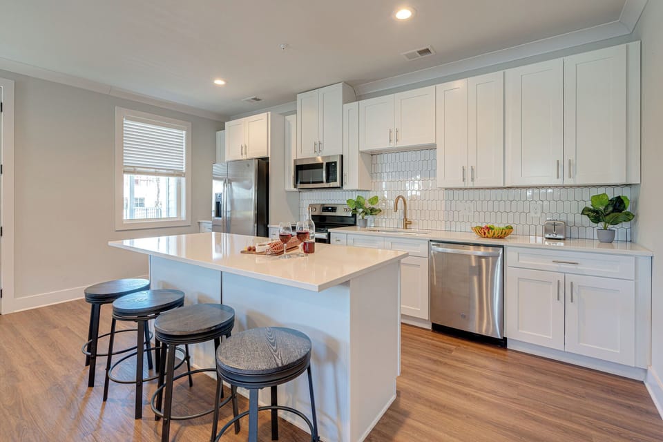 Unit 1: Fully Equipped Kitchen stocked with basic cooking essentials and stainless-steel appliances.