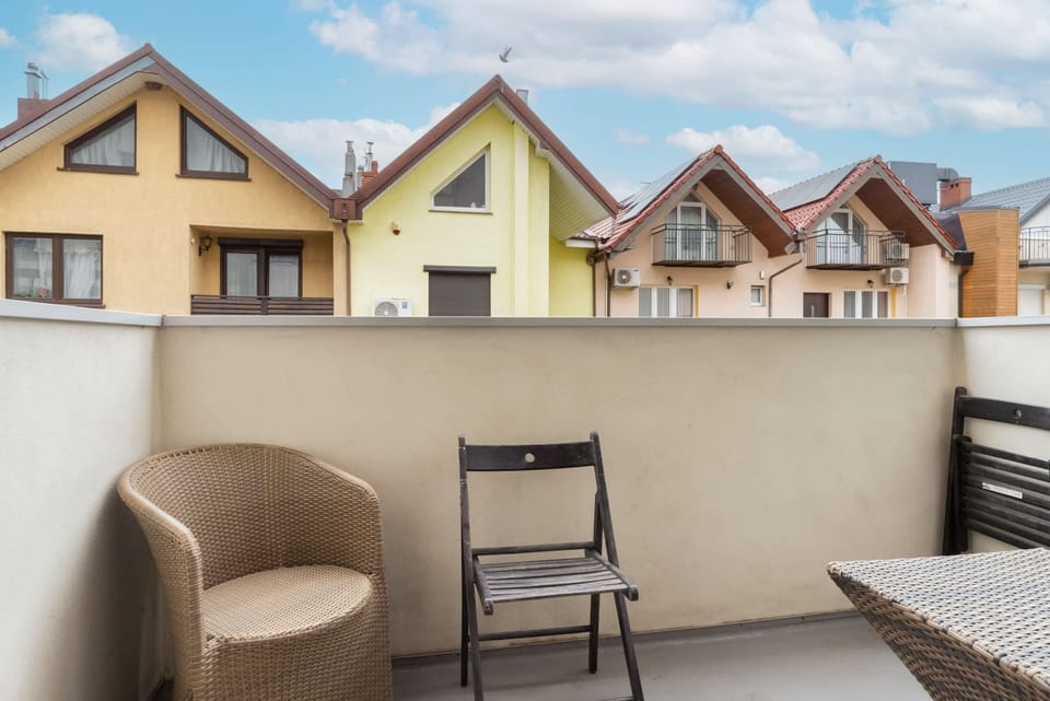 A balcony with a seating area, offering a peaceful outdoor space for relaxation.

