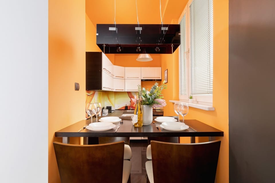 A small dining area with a wooden table, set for a welcoming meal.

