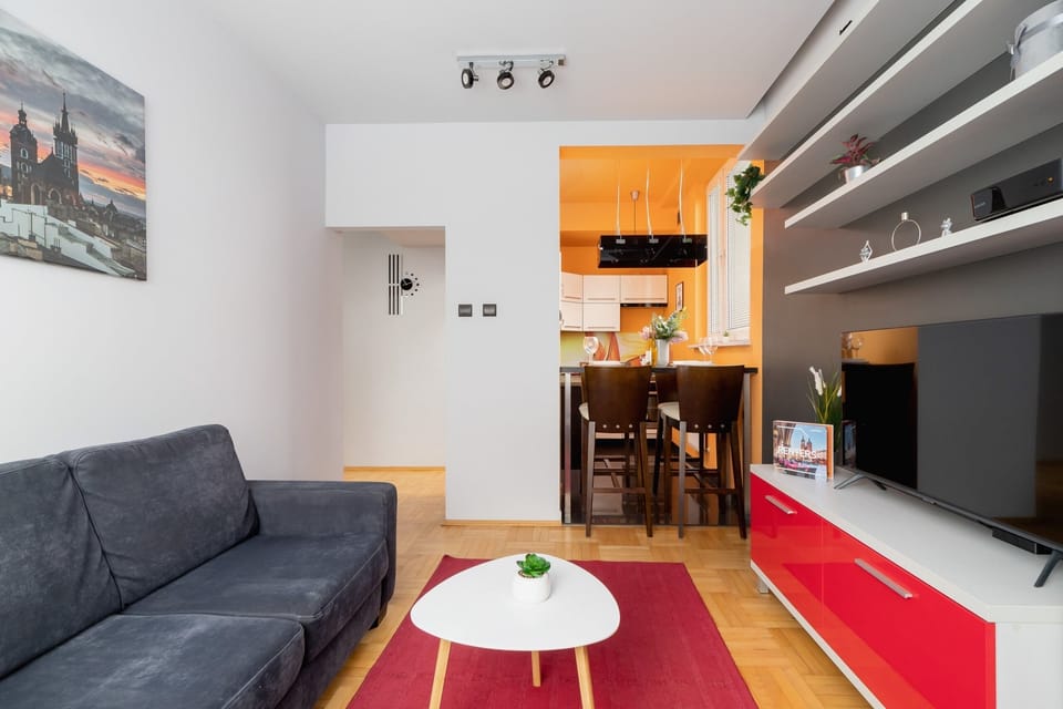 A combined living and dining area with red and gray accents, creating a vibrant space.
