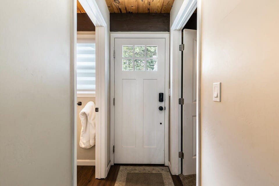 The view of the front door of the home. Guests will find a bathroom and bedroom on each side of the front door.