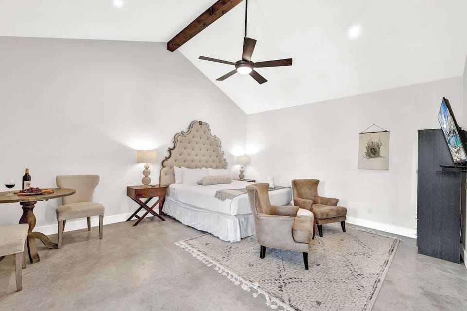 Spacious bedroom with seating for two.