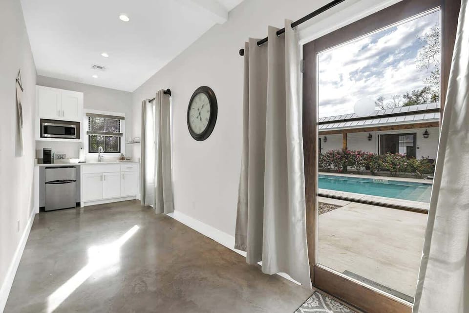 Large doors open to the shared pool area.