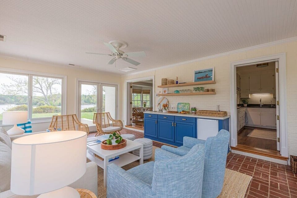 Lounge here all day if you like! Grab a book or games and gather around. Perfect vantage point for all the goings-on outside at the pool and on the expansive lawn with corn hole and other games!