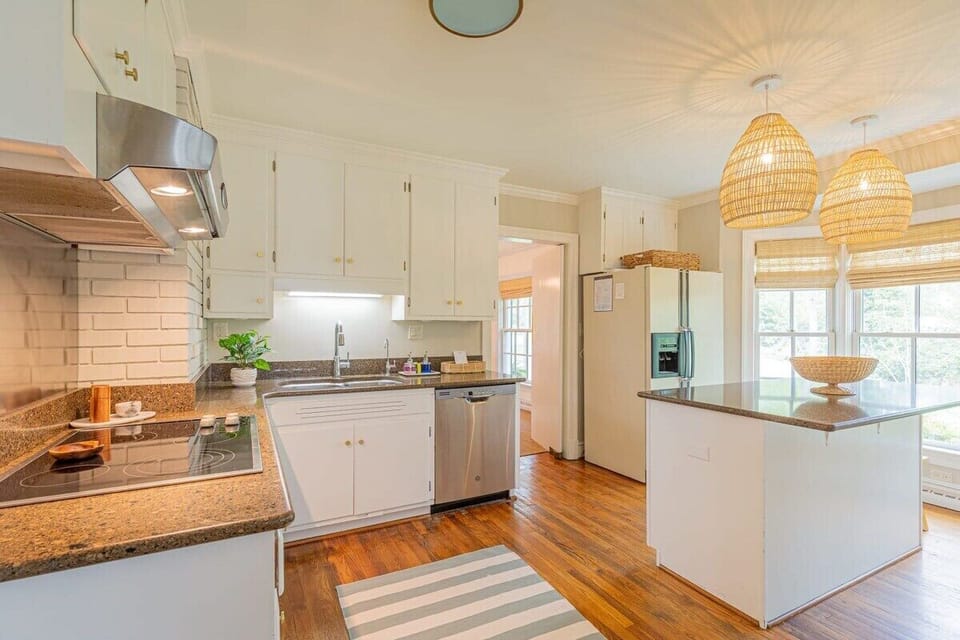 Our well-stocked kitchen is great for preparing family meals. Coffee bar with regular, decaf, and teas. Filtered water at sink. Side-by-side fridge. Doors lead to three rooms: dining, living, and sun room.
