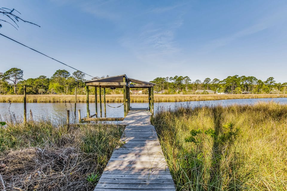 The pier and boat dock offer easy access to deep water for boating and fishing. With 80 feet of prime waterfront access, this property is a boater and fisherman's paradise.
