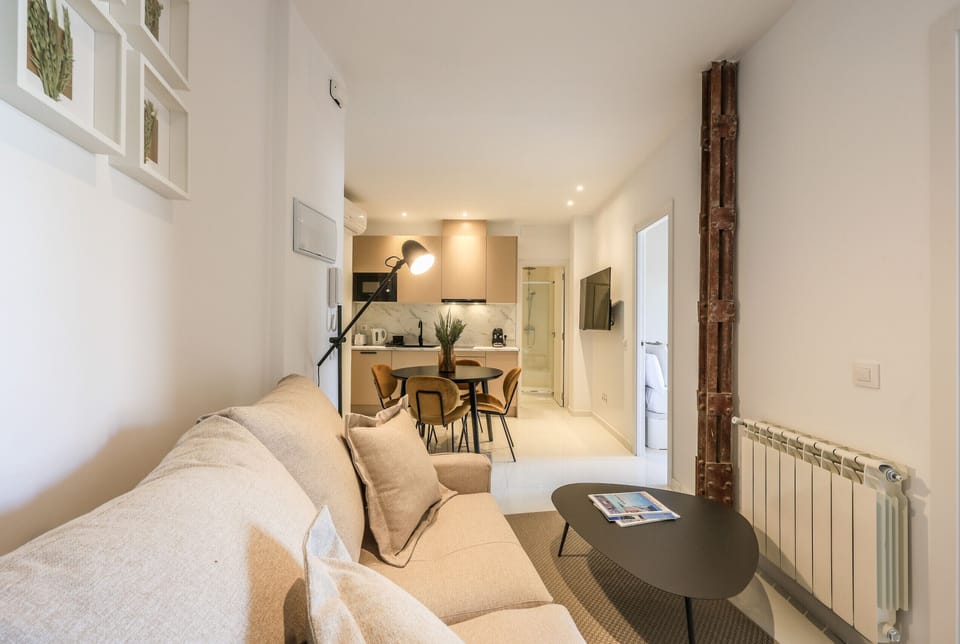 View of the living room with kitchen and dining room in the background