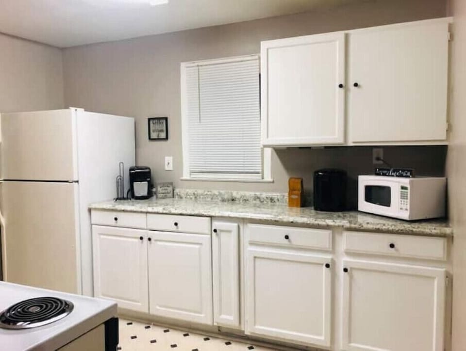 The kitchen is fully stocked with plates, pots, spices and even a bread maker!