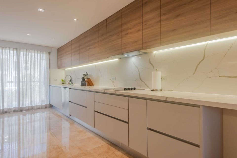 Cook with ease in a sleek, fully equipped kitchen featuring top appliances and ample space.
