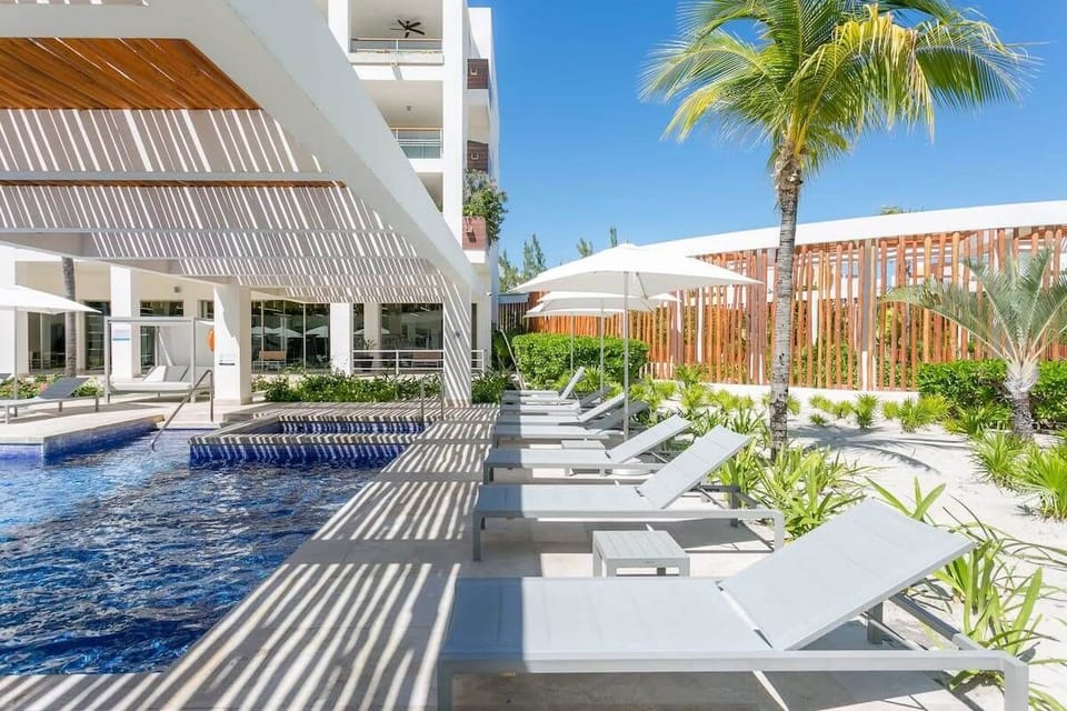 Spend your days soaking up the sun by the pool, surrounded by tropical palms and tranquil vibes.