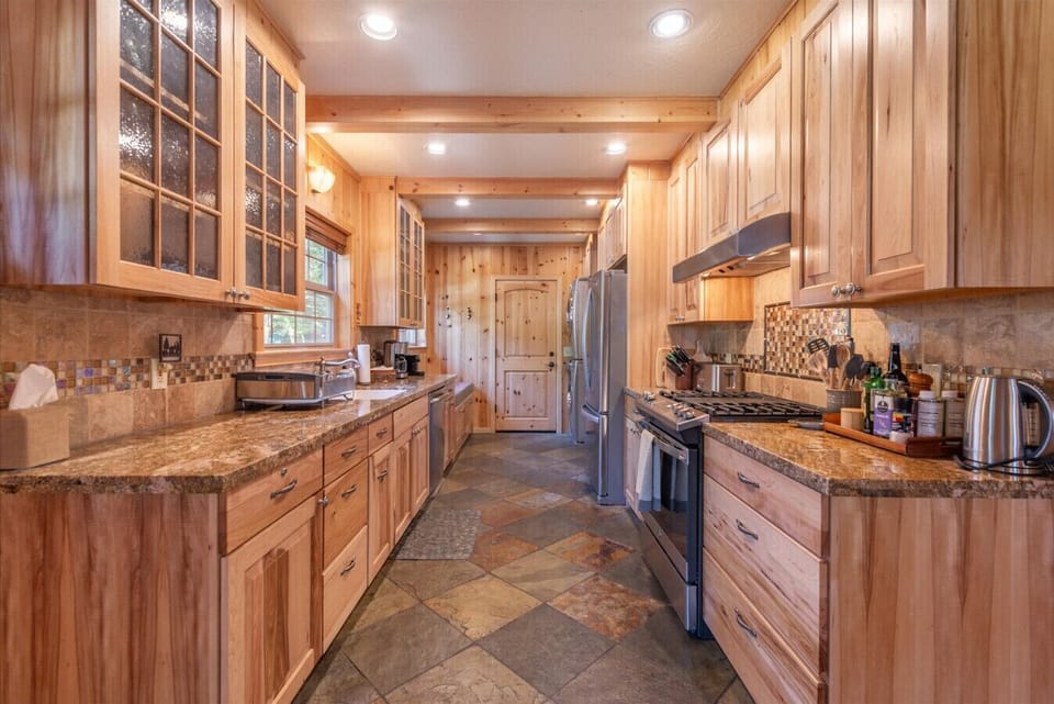 Well appointed kitchen with granite counter tops and stainless steel appliances.